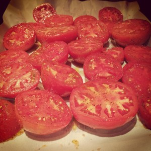 a layer of seasoned tomatoes on the baking sheet